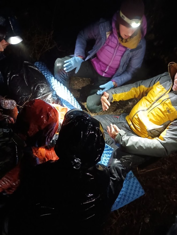 Students during a Wilderness First Responder nighttime scenario practice